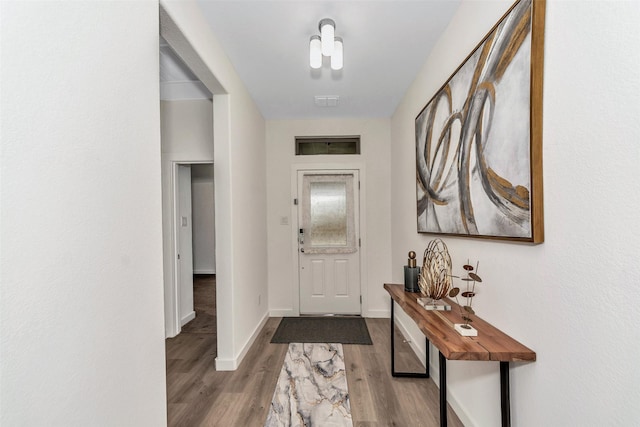 entrance foyer with baseboards and wood finished floors