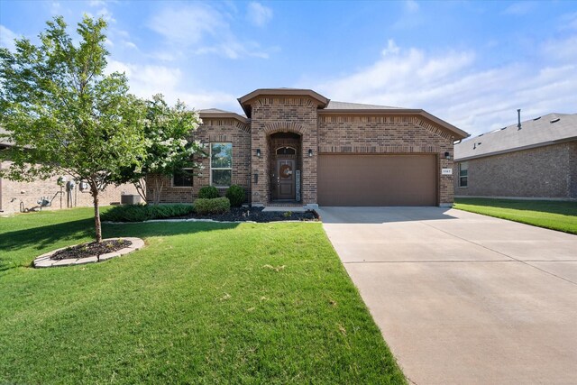 view of front of property with a garage and a front yard