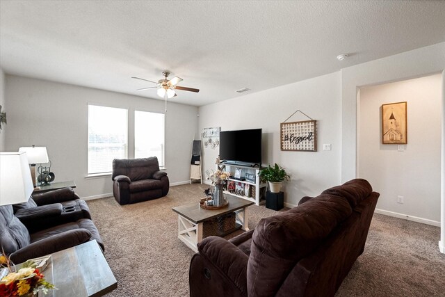 carpeted living room with a textured ceiling and ceiling fan