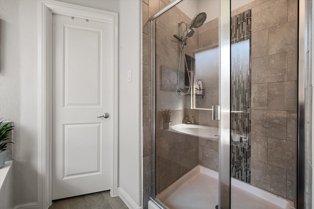 bathroom featuring a shower with shower door