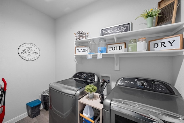 washroom featuring washing machine and dryer and hardwood / wood-style floors