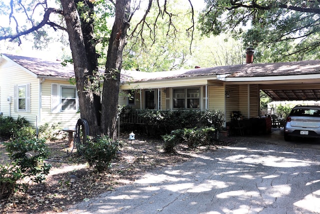 single story home featuring a carport