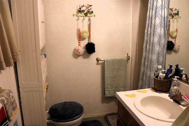 bathroom featuring vanity and toilet