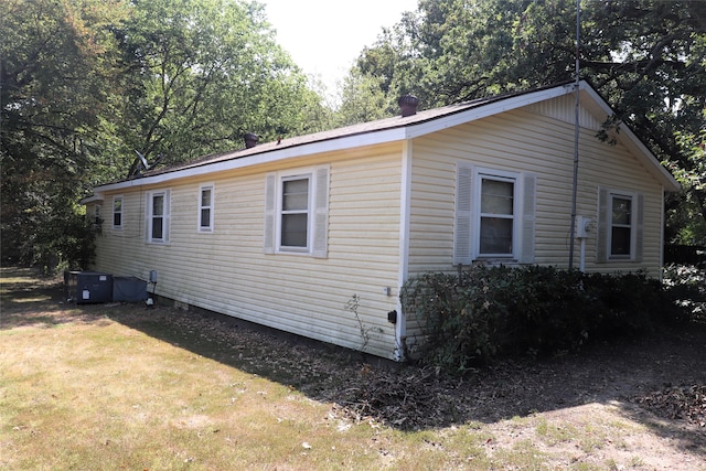 view of side of home with a yard