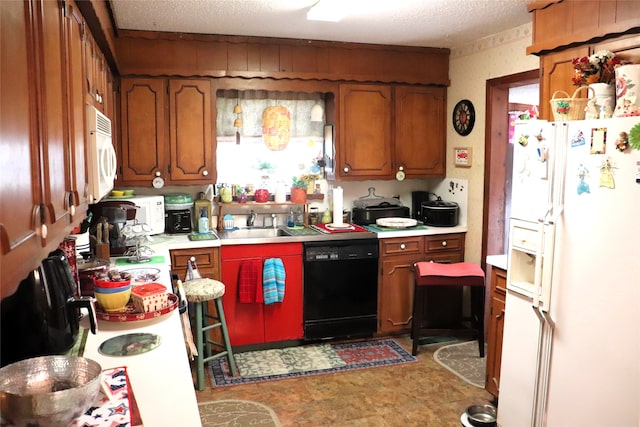 kitchen with sink, a textured ceiling, white appliances, and light tile patterned floors