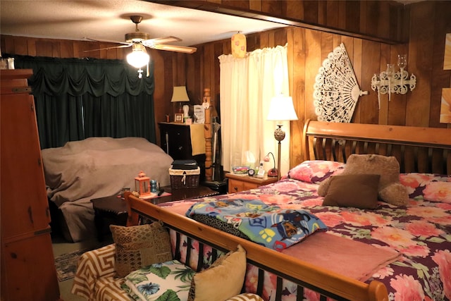 bedroom with wooden walls and ceiling fan