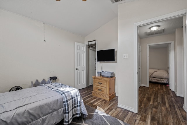 bedroom featuring ceiling fan, dark hardwood / wood-style flooring, and vaulted ceiling