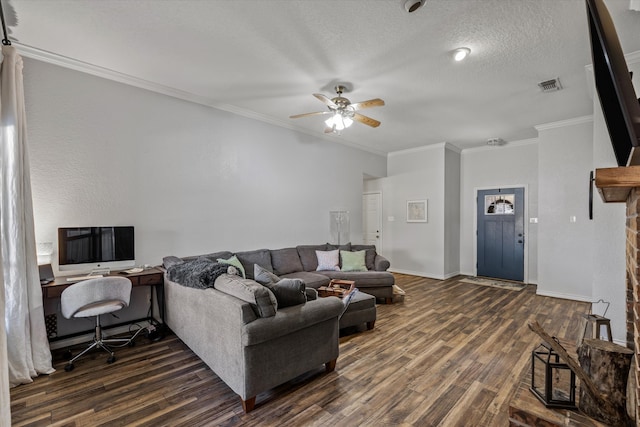 living room with a textured ceiling, ornamental molding, dark hardwood / wood-style flooring, and ceiling fan