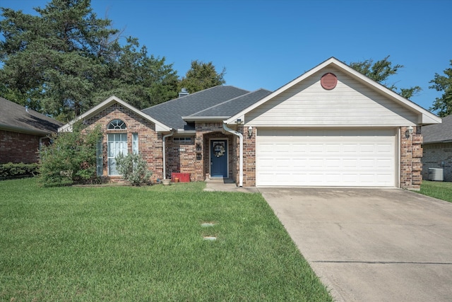 single story home featuring a front lawn, cooling unit, and a garage