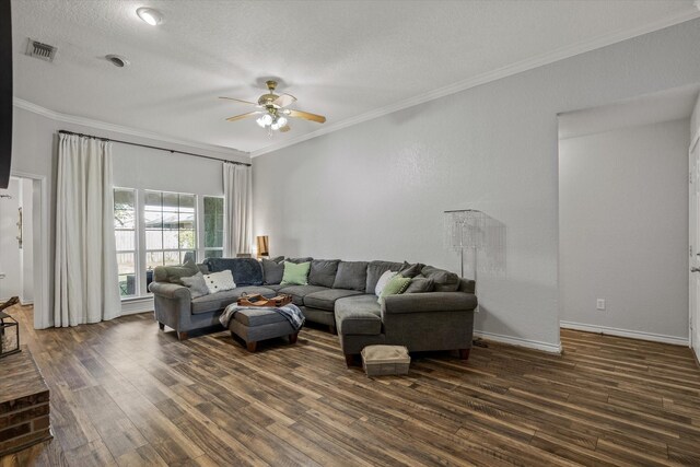 living room featuring dark wood-style floors, ceiling fan, visible vents, and crown molding