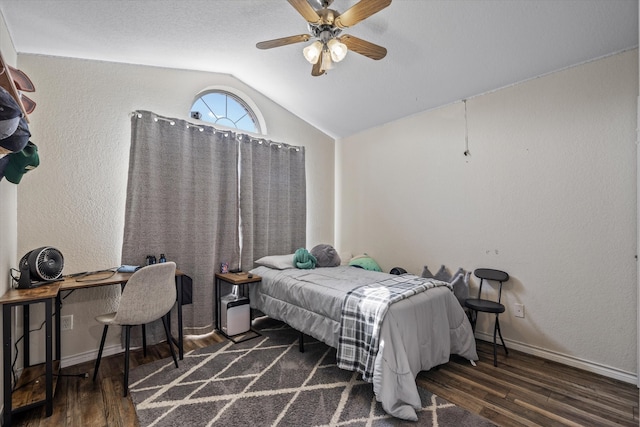 bedroom featuring ceiling fan, dark hardwood / wood-style floors, and vaulted ceiling