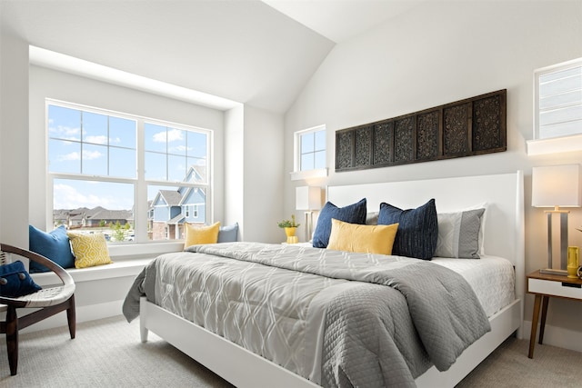 carpeted bedroom with vaulted ceiling