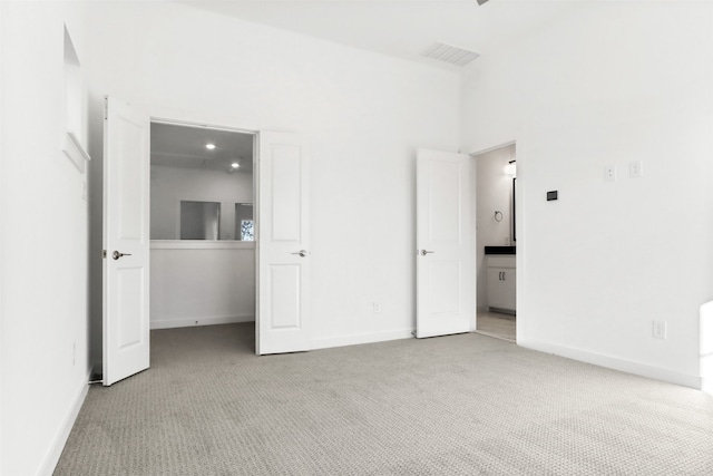 unfurnished bedroom with light colored carpet