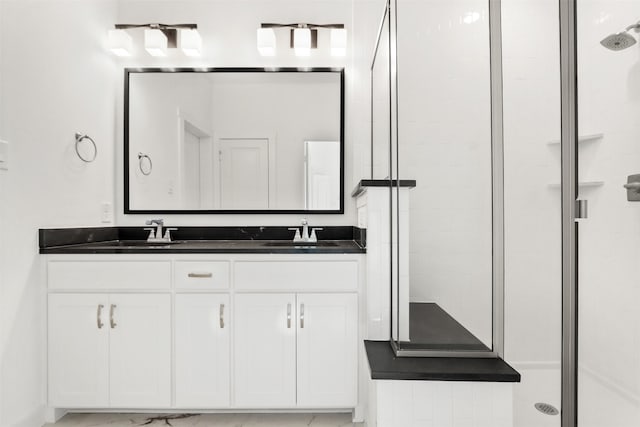 bathroom featuring vanity and a shower with shower door