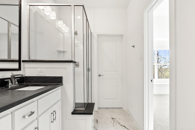 bathroom featuring vanity and a shower with shower door