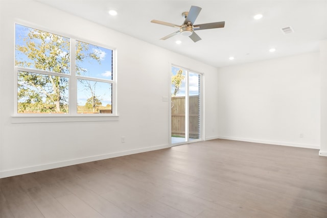 spare room with hardwood / wood-style flooring and ceiling fan