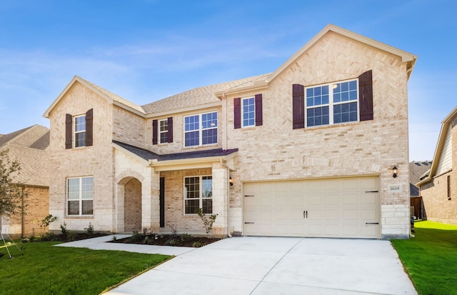 view of front of house featuring a front yard and a garage