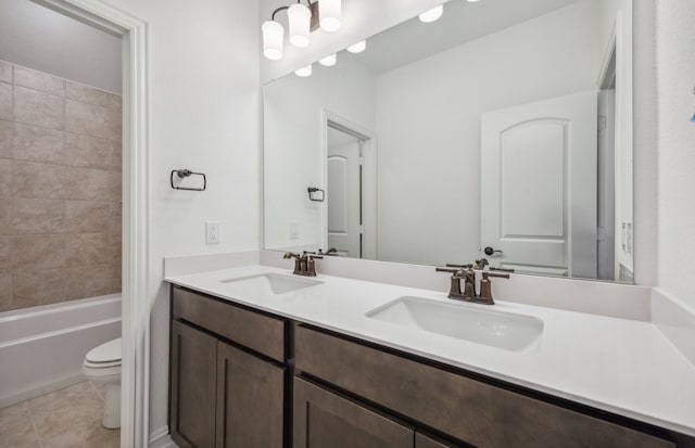 full bathroom featuring vanity, toilet, tiled shower / bath combo, and tile patterned flooring