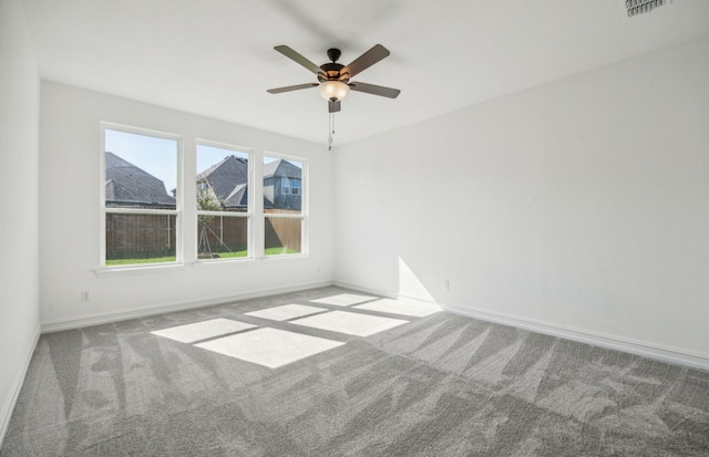 empty room featuring carpet flooring and ceiling fan