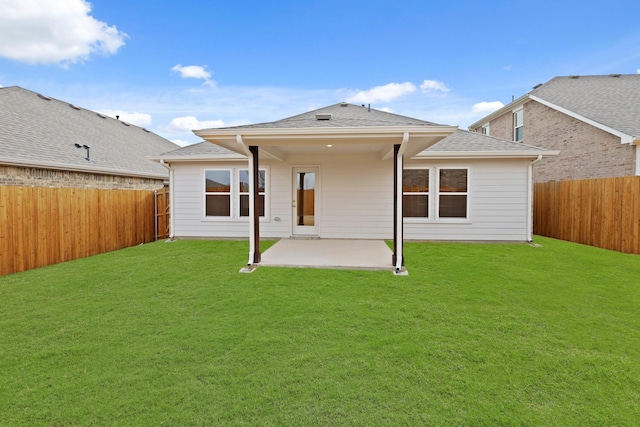 back of house with a lawn and a patio