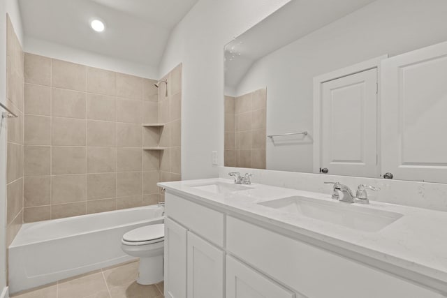 full bathroom featuring vanity, tile patterned floors, toilet, and tiled shower / bath