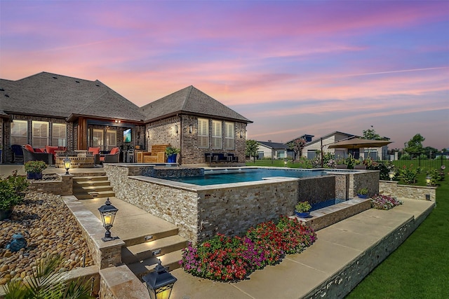 pool at dusk featuring a fenced in pool, an outdoor hangout area, fence, and a patio area