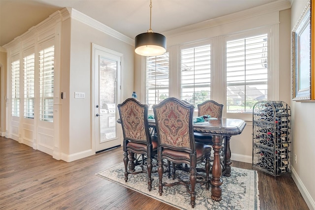 dining area with baseboards, dark wood-type flooring, and ornamental molding