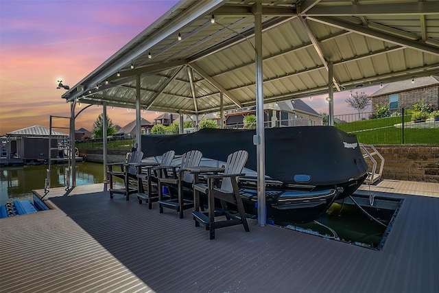 dock area with fence, a water view, and boat lift