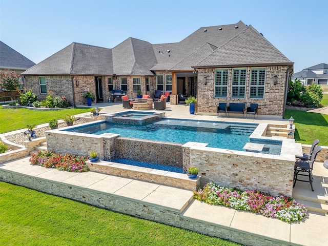 view of pool featuring a lawn, an in ground hot tub, and a patio area