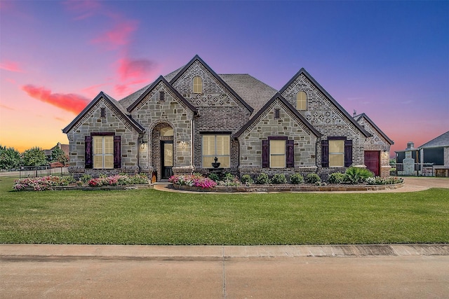 view of front of home with a front lawn and brick siding