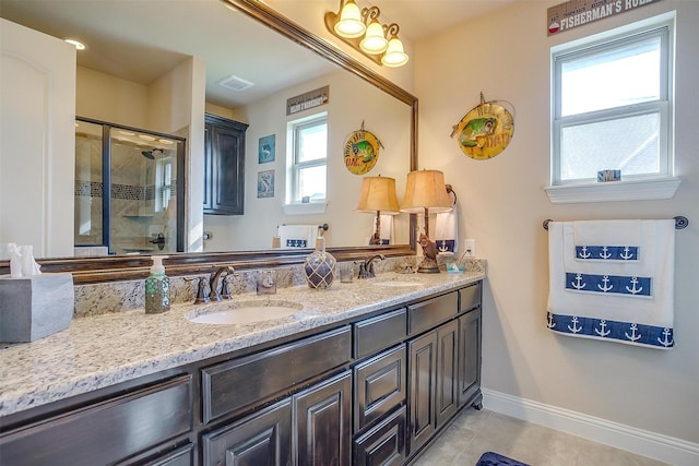 bathroom featuring a stall shower, visible vents, a sink, and double vanity