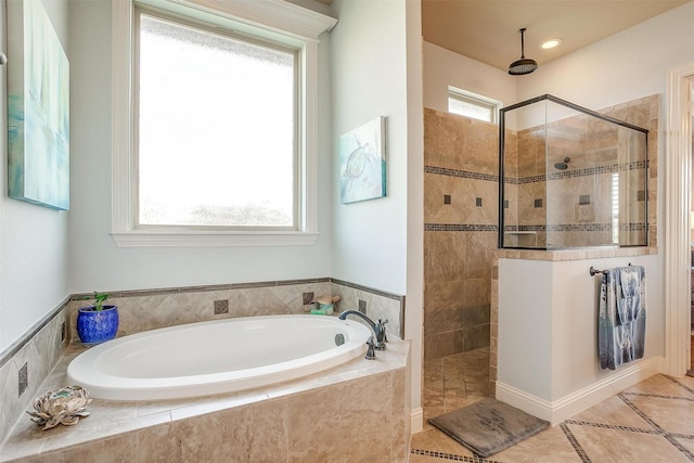 full bath with tile patterned floors, walk in shower, and a garden tub