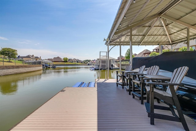 view of dock featuring a water view and a residential view