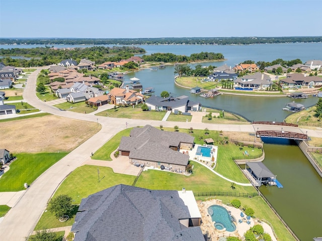 drone / aerial view with a residential view and a water view