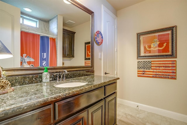 bathroom featuring visible vents, baseboards, a shower with curtain, and vanity