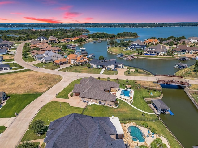 birds eye view of property with a residential view and a water view