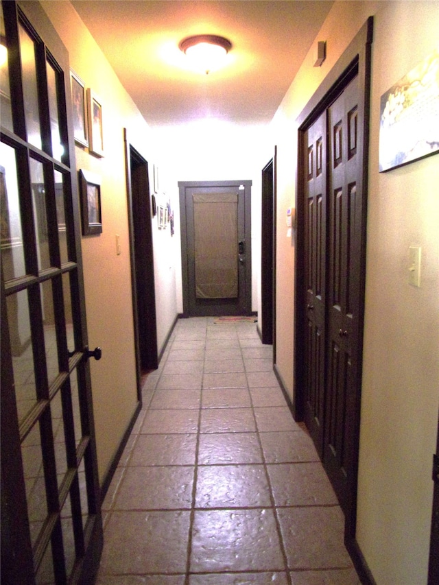 hall with light tile patterned floors