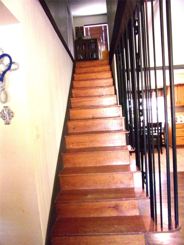 staircase with wood-type flooring