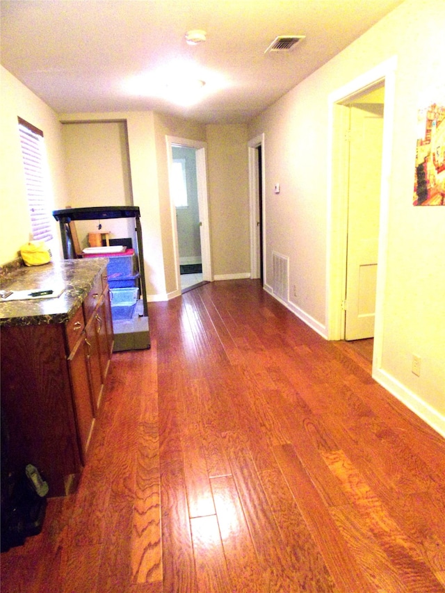 interior space featuring wood-type flooring and ensuite bath