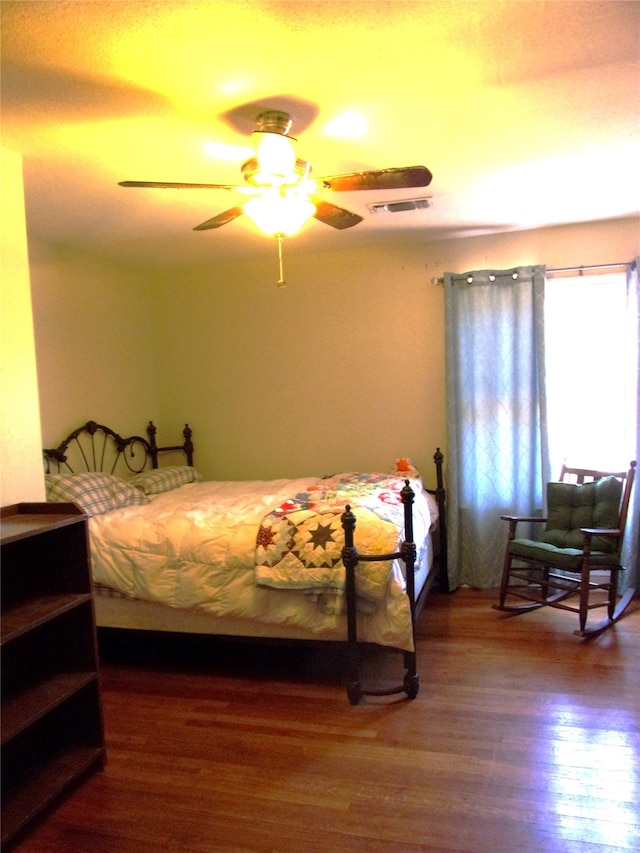 bedroom with ceiling fan and hardwood / wood-style flooring