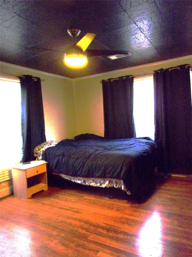 bedroom featuring ceiling fan and hardwood / wood-style floors