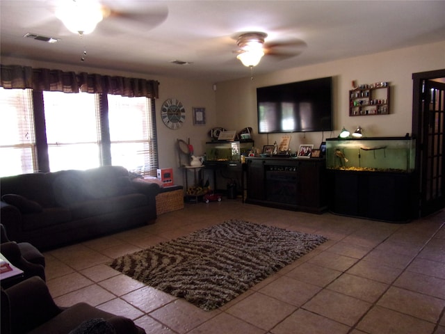 living room with ceiling fan and light tile patterned flooring