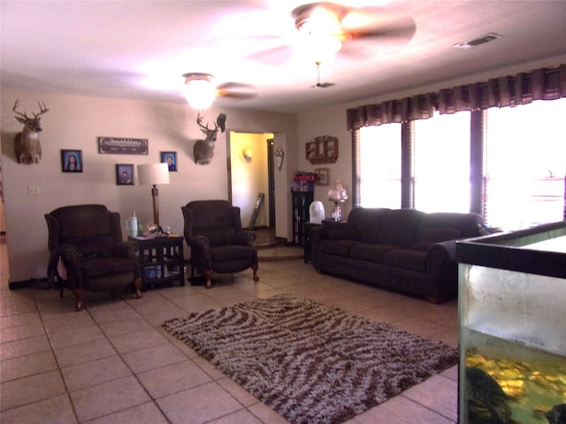 tiled living room with ceiling fan