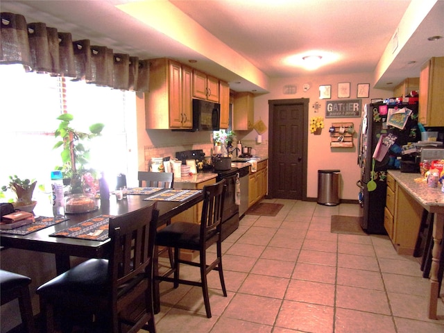 kitchen featuring range with electric stovetop and light tile patterned floors