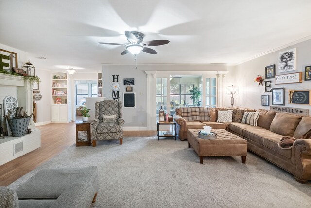 living room featuring light hardwood / wood-style flooring, ornamental molding, plenty of natural light, and ceiling fan