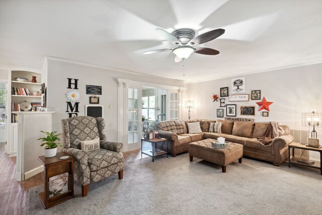 living room featuring ceiling fan, wood-type flooring, and crown molding