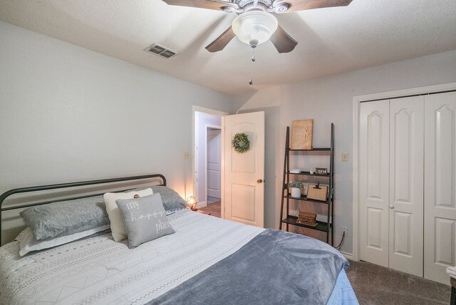 bedroom with ceiling fan, a closet, and carpet floors