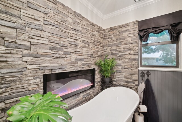 bathroom featuring ornamental molding and a stone fireplace