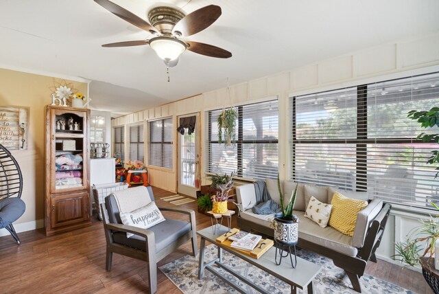 living room with ceiling fan and hardwood / wood-style flooring