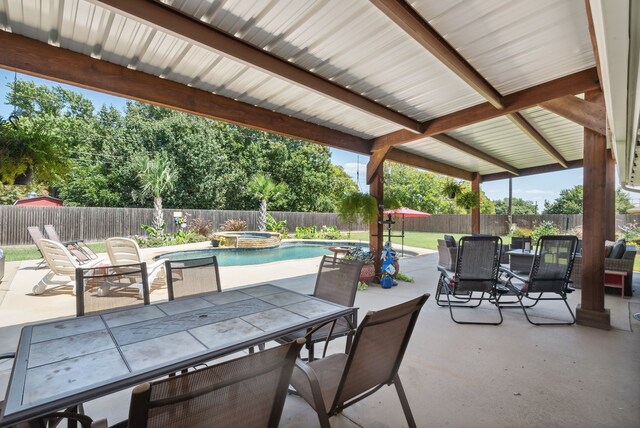 view of patio / terrace with a pool with hot tub